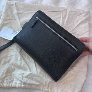 Salvatore Ferragamo black leather clutch with a detachable wrist strap